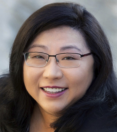 Woman with black hair wearing prescription glasses