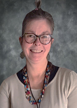 Woman wearing glasses with hair in a bun