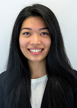 Woman with long staight black hair wearing a dark blazer over white shirt