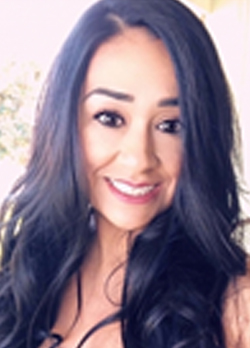 Woman with long wavy black hair smiling